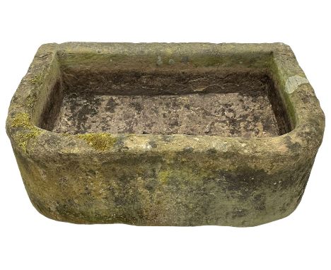 Large weathered sandstone D-shaped trough, roughly tooled exterior and deeply hewn centreDimensions: Height:&nbsp;33cm&nbsp; 