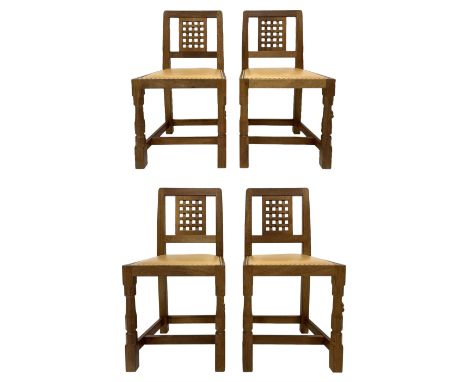 Mouseman - set four oak dining chairs, lattice carved back, upholstered in tan leather with studded band, the octagonal front