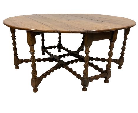 19th century oak drop-leaf dining table, oval top with quadruple gate-leg action base, spiral turned supports united by spira