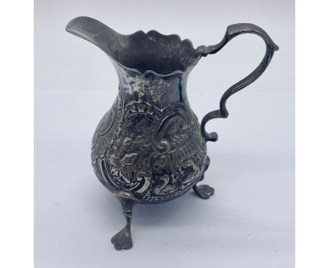 A hallmarked silver cream jug with embossed detailing, weight 71.3g