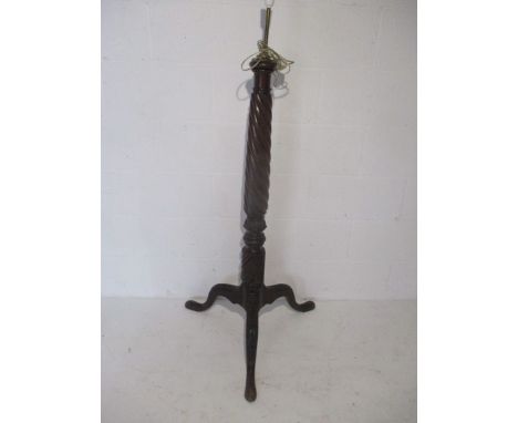A Victorian standard lamp with barley twist support on carved tripod base  
