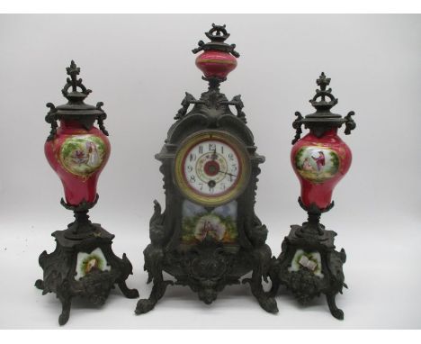 A turn of the century French clock garniture with hand painted porcelain panels