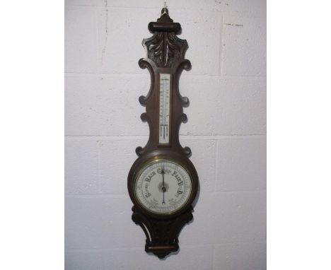 A Victorian carved aneroid barometer