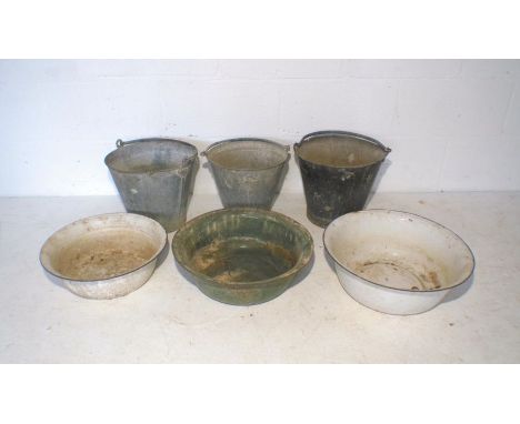 Three galvanised metal buckets, along with three enamel bowls.