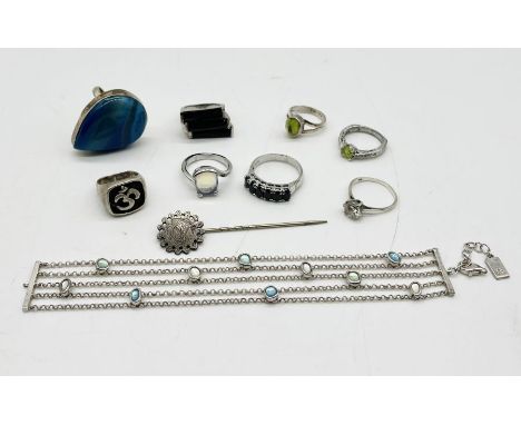 A collection of 925 silver rings along with a silver bracelet