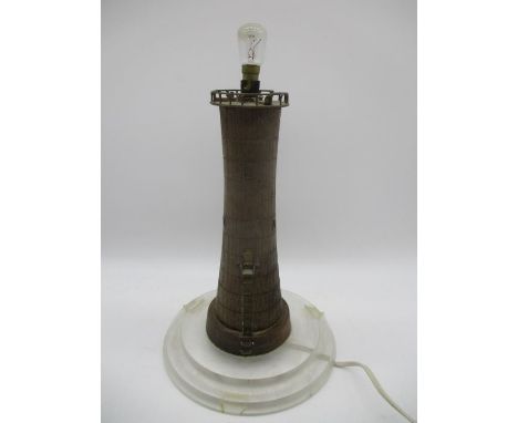 A wooden lamp in the form of a lighthouse on tiered perspex base 