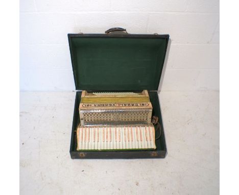A cased Casali-Verona pink accordion.