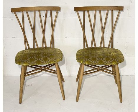 A pair of Ercol candlestick chairs with cross over backs - in need of some restoration