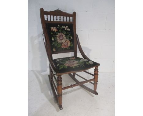 A turn of the Century rocking chair with tapestry seat and back, stamped "655 JJ" to reverse