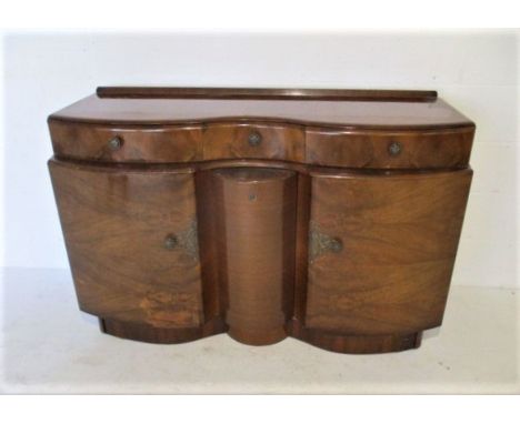 An Art Deco serpentine fronted sideboard, with revolving centre panel to reveal cocktail storage, length 138cm, height 77cm.