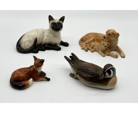 A small collection of ceramic animals including Royal Doulton Siamese Cat and Labrador with puppies along with a duck and fox