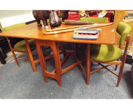 A teak G-Plan gate leg table and four G-Plan chairs with green upholstery