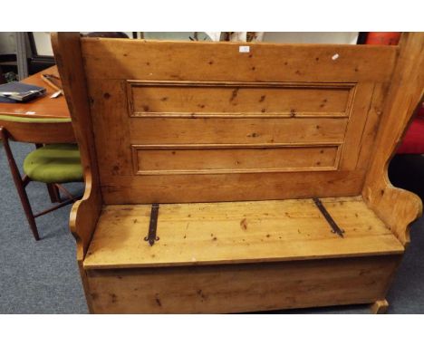 A vintage pine settle with hinged seat