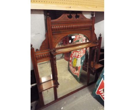 An Edwardian over mantle mirror having carved pediment above a galleried shelf