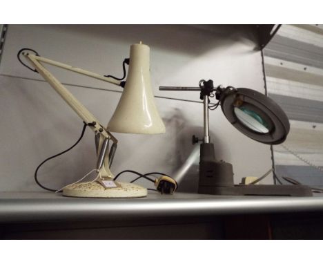 A vintage desk lamp with a magnifying lens, together with a vintage anglepoise lamp