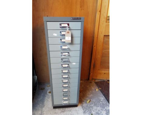 A vintage metal filing cabinet with fifteen drawers