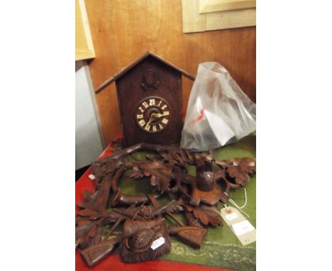 A Bavarian cuckoo clock having carved pediment with stag, carved mount in hunting design and ivorine hands (no balance)  Mode