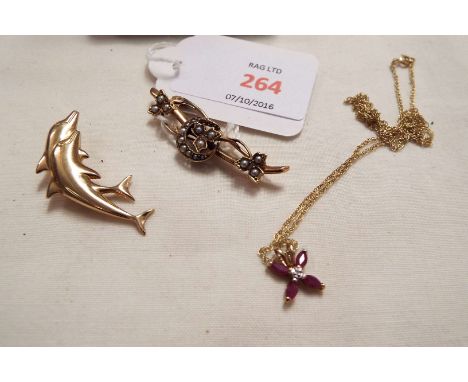 A 9ct gold dolphin brooch, ruby and diamond set pendant on chain and an Edwardian seed pearl brooch