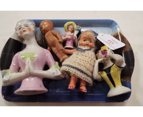 A selection of pin dolls and two ceramic dolls