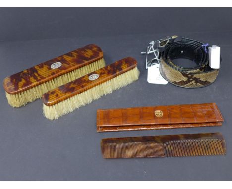 A cased Asprey tortoiseshell hair comb, with matching tortoiseshell and diamond set brushes, and a crocodile skin belt