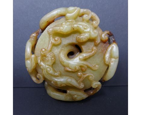 A 19th century Chinese jade paperweight, with pierced carvings of dragons, Diameter 6cm 