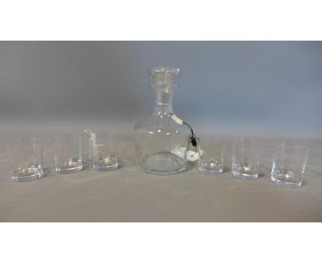 A mid 20th century glass decanter, with acid etched decoration of a gentleman holding an oil lamp by a four poster bed, engra