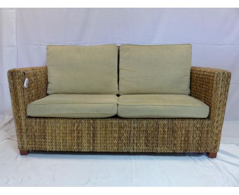 A rattan conservatory sofa with cushions, H.83 W.161 D.82cm 