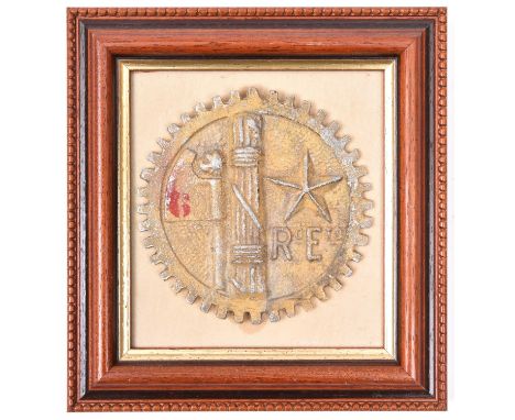 A WWII Italian cast aluminium vehicle badge from the North African campaign, in the form of a cogwheel enclosing fasces with 