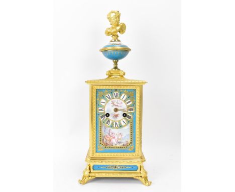 A late 19th century French mantle clock, the gilt metal case cast with floral scoll decoration, winged cherub finial and inse