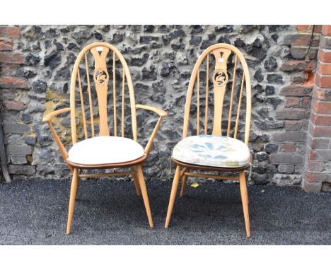 An Ercol vintage gold label, elm seated and beech framed swan back carver chair and matching dining chair, both having spindl