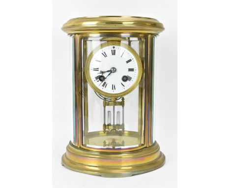A late 19th/early 20th century French mantle clock, having a lacquered brass case with curved bevelled glass panels, 3" white