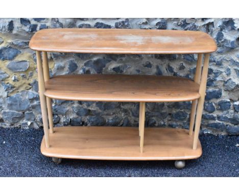 A mid 20th century Ercol elm and beech Baby Giraffe three tier trolley, model 361, Windsor range, incorporating a magazine di