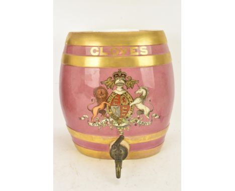 A Victorian ceramic cloves barrel, of oval shape and decorated with a pink ground with gilt bands and painted with a coat of 