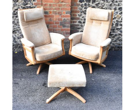 A pair of vintage Ercol Gina light elm manual reclining armchairs upholstered in beige fabric with headrests and one matching