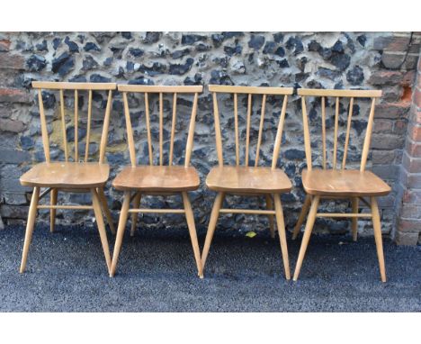 A set of four Ercol blonde elm and beech kitchen dining chairs, model 391, having spindle stick back supports, stretchers bel