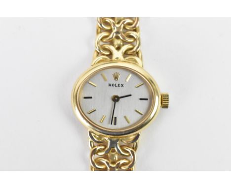 A Rolex, manual wind, ladies, 14ct gold dress watch, circa 1993, having a oval silvered dial, baton markers, on a integral 14