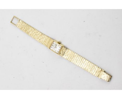 A Certina, manual wind, ladies, 9ct gold wristwatch, the silvered dial having baton markers and fitted with a 9ct gold integr