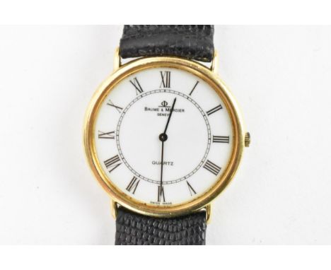 A Baume &amp; Mercier, quartz, gents, 18ct gold wristwatch, having a white dial with black Roman numerals, on a black leather