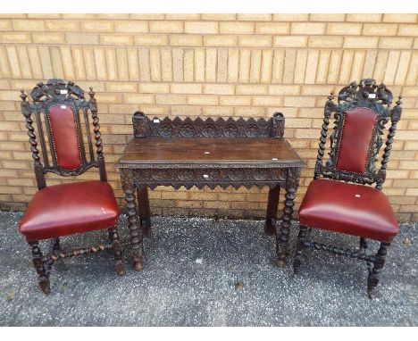 Two chairs with carved decoration and leather upholstery and a similar console table approximately 93 cm x 103 cm x 41 cm. [3