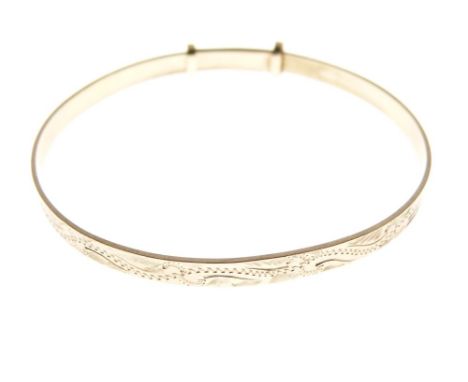 9ct gold bangle of adjustable design with wavy external decoration, 7.3g approx  