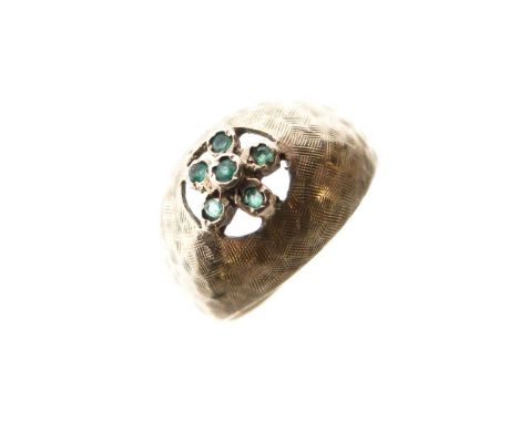 Yellow metal and green stone dress ring of flowerhead design, shank stamped 14k, size K, 2.9g gross approx  