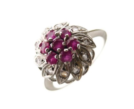 White metal, diamond and ruby cluster ring of flowerhead design, shank stamped K18, size N, 3.4g gross approx  