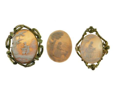 Two gilt metal shell cameo brooches, each depicting figures in landscapes, the larger 48mm x 35mm excluding frame, together w