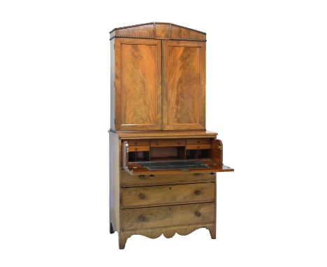 Early 19th Century mahogany secretaire bookcase, the upper section having architectural pediment by a pair of doors enclosing