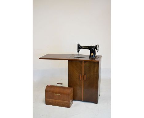 Singer sewing machine Y5710959 in original oak arch-top case, together with a sewing cabinet enclosing original Singer treadl