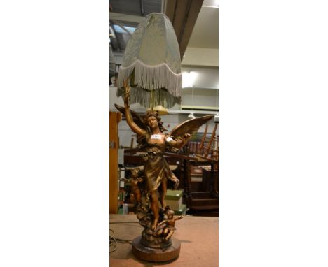 A bronzed spelter figural lamp, modelled as a warrior holding aloft a flamiform shade