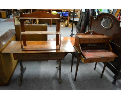 An Edwardian mahogany slant front writing desk, a Regency mahogany sofa table and a three tier mahogany hanging shelf 