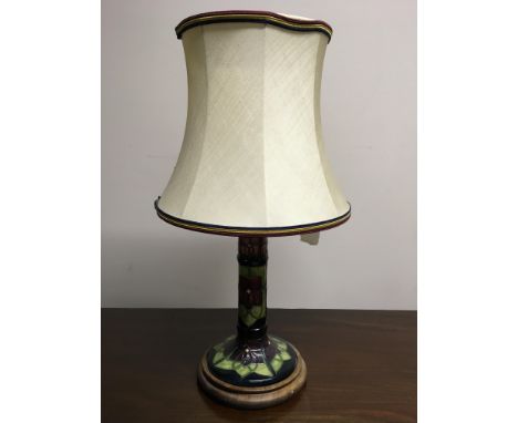 A Moorcroft table lamp base with floral green, pink, and purple pattern. IMPORTANT: Online viewing and bidding only. Collecti