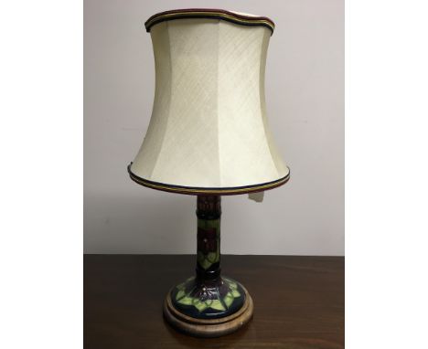 A Moorcroft table lamp base with floral green, pink, and purple pattern. IMPORTANT: Online viewing and bidding only. Collecti