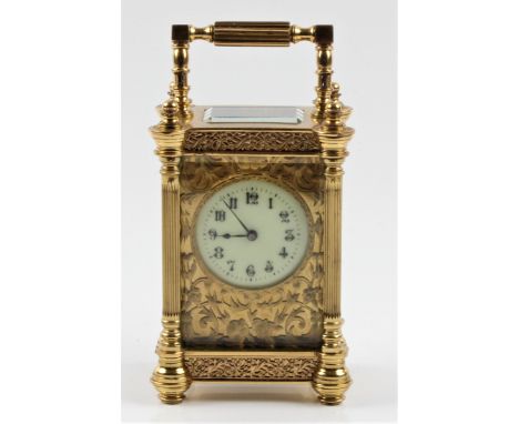 A small brass carriage clock with floral fret work design throughout and five glass panels, approx 13cm x 6.5cm x 5cm. IMPORT